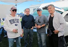 Four faculty members talking at the football tailgate