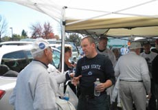 alumni and friends talking at the football tailgate