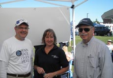 Alumni, staff, and faculty pose for a picture at the football tailgate