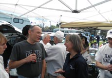 alumni and friends talking at the football tailgate