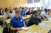 grad students listening to information presented to them during graduate student orientation