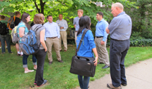 Students and faculty members standing outside and talking at the student alumni mixer