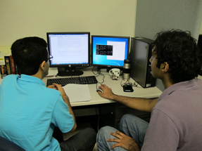 Two students solving problems on the computer