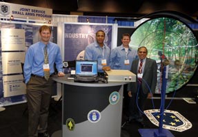 Three students and a faculty members displaying their research